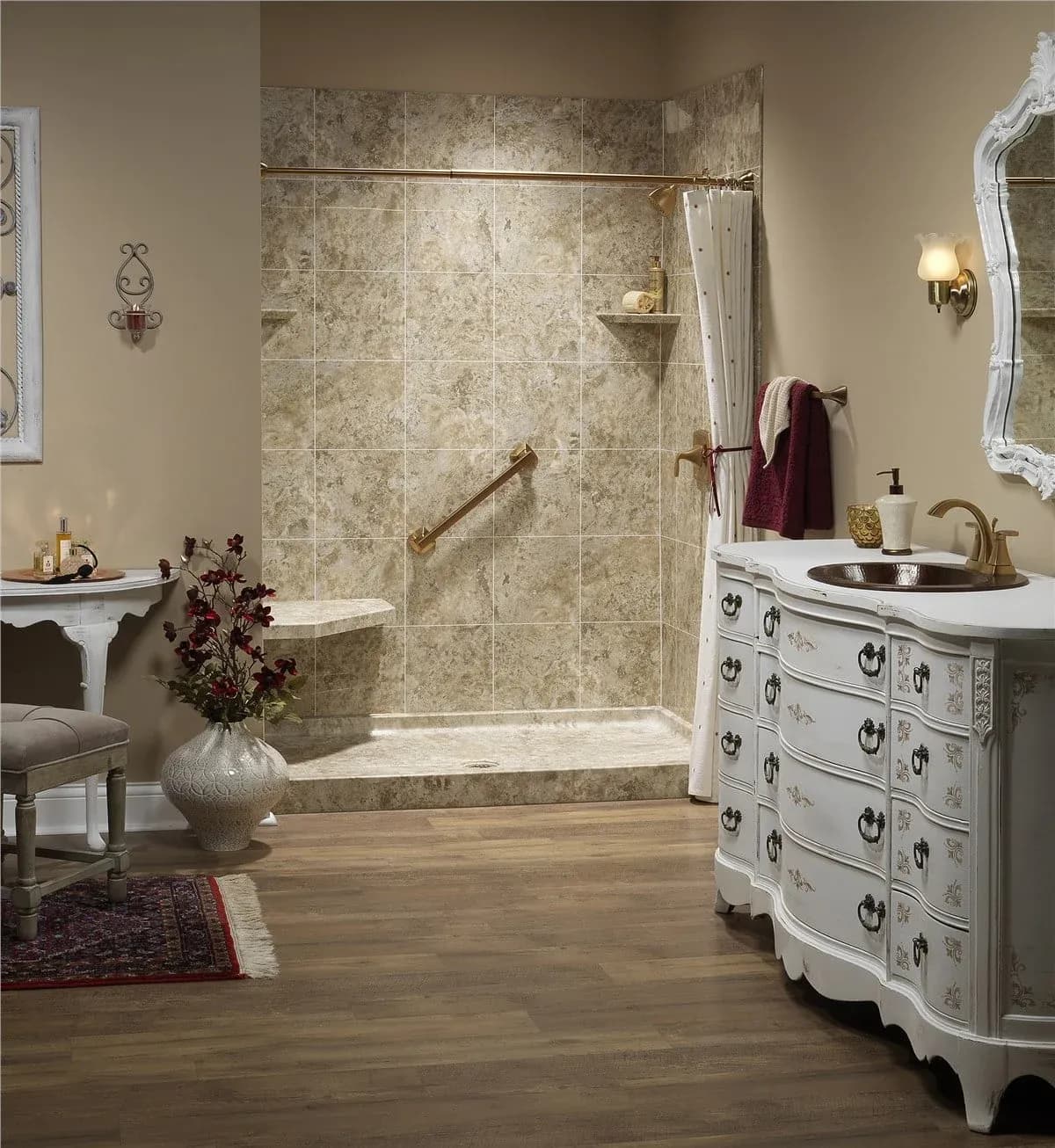 Luxurious spa-style bathroom with tiled walk-in shower, white curved vanity, pedestal sink, decorative mirror, and wood flooring throughout